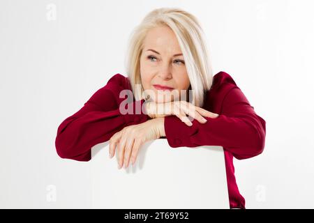Sad lonely middle age woman. female depression, Portrait of a middle aged woman sitting in a chair and looking sad, Woman looks sad and dejected, upse Stock Photo