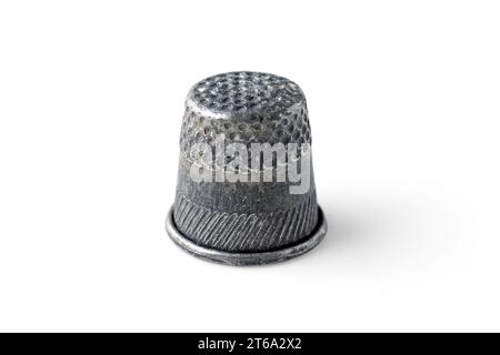 Old worn metal thimble for hand sewing isolated on white background Stock Photo