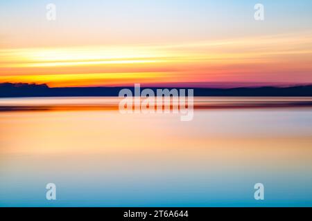 Motion blurred abstract lake at sunset background or wallpaper Stock Photo