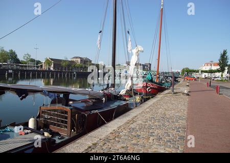 70 year old steel swing bridge Stationsbrug (Station Bridge) over the canal (Kanaal door Walcheren), old sailing boats, station. Zeeland, Middelburg Stock Photo