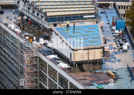 Inspector controlling new window of a light well on the roof of a commercial building. Stock Photo