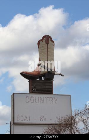 Giant Cowboy Boot on Sign of Abandoned Business Located in Rural Texas. Weir Texas Stock Photo