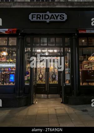 Entrance to FRIDAYS bar and restaurant at night, High Street, Lincoln City, Lincolnshire, England, UK Stock Photo