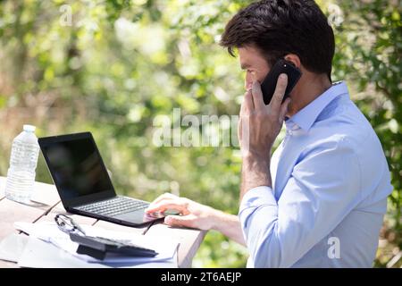 man working on his computer outdoors Stock Photo