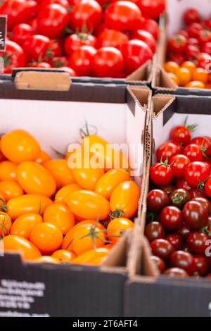 Close up of different kinds of tomatoes in paper boxes Stock Photo