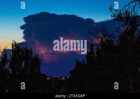Intra cloud lightning in a thunderhead cumulonimbus cloud at dusk over Gloucester, England UK Stock Photo
