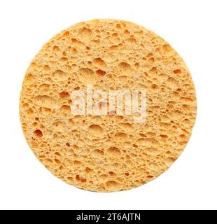 Round yellow porous sponge for facial skin care on a white background. Skin care. Cosmetic disc sponge. View from above Stock Photo