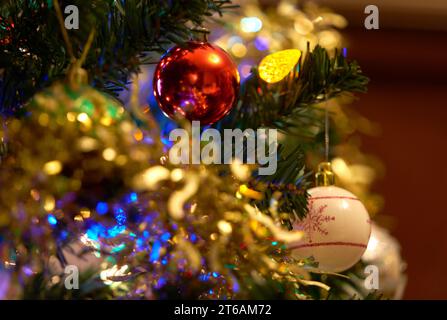 Christmas Tree Baubles and Decorations. Festive holiday decorations on a Christmas tree. Stock Photo