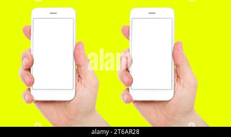 set two different phones with blank display isolated on yellow background, male hands hold phones Stock Photo