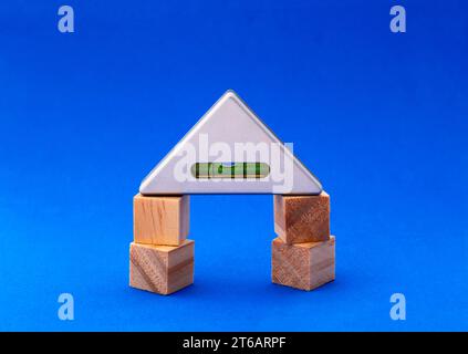 Triangular bubble level on four wooden blocks Stock Photo