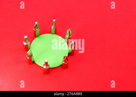 Set of drill bits with different shapes surrounding a green circle Stock Photo