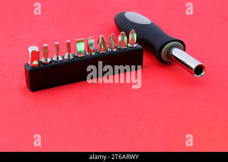 Screwdriver with set of bits arranged in a row Stock Photo