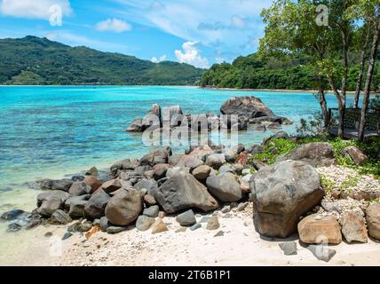 Small beach with rocks on Mahe Island, Seychelles. Stock Photo