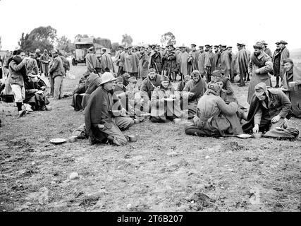 Italian prisoners of war eating a meal after detraining at Wadi al-Sarar Railway Station, Mandatory Palestine, G. Eric and Edith Matson Photograph Collection, December 21, 1940 Stock Photo