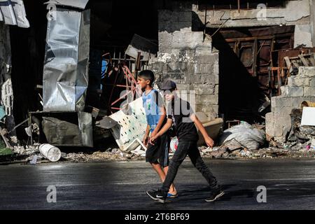 Tulkarm, Palestine. 08th Nov, 2023. Palestinians walk through a damaged house in the street after an Israeli military raid in Tulakrem refugee camp in the West Bank. (Photo by Nasser Ishtayeh/SOPA Images/Sipa USA) Credit: Sipa USA/Alamy Live News Stock Photo