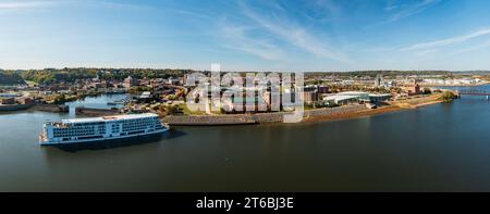 Dubuque, IA - 17 October 2023: Aerial view of Viking Mississippi river cruise boat docked by modern convention center on Mississippi river in Iowa Stock Photo