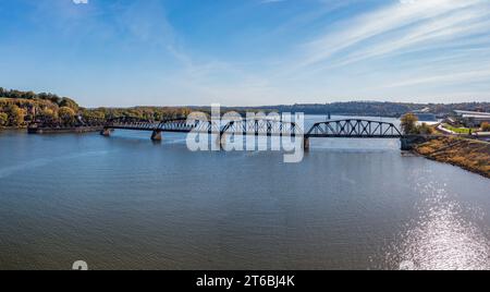 Aerial view of historic Dubuque railroad bridge between Iowa and Illinois across the Mississippi river with cruise boat in distance Stock Photo