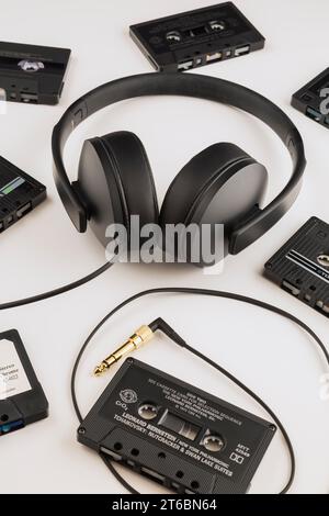 Sennheiser HD 300 stereo headphones with gold plated headphone jack and audio tape cassettes on white background. Stock Photo