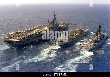 USNS Navasota (T-AO-106) refuels USS Midway (CV-41) and USS England (CG-22) on 7 December 1983 (6483143) Stock Photo