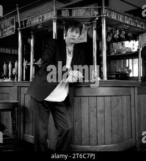 Legendary Irish rockstar, singer/songwriter & frontman for The Pogues & The Popes, Shane MacGowan pictured drinking and smoking at his favourite London pub Filthy MacNasty’s , Islington 1994 Stock Photo