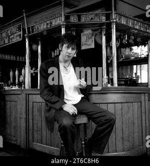 Legendary Irish rockstar, singer/songwriter & frontman for The Pogues & The Popes, Shane MacGowan pictured drinking and smoking at his favourite London pub Filthy MacNasty’s , Islington 1994 Stock Photo