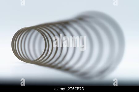 Cornucopia-like angular macro view of a  spring with the distant end in focus, giving the optical illusion that it is the near end. Stock Photo