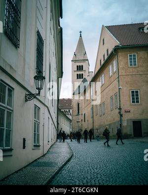 Church tower and cobblestone street at Prague Castle, Prague, Czechia Stock Photo