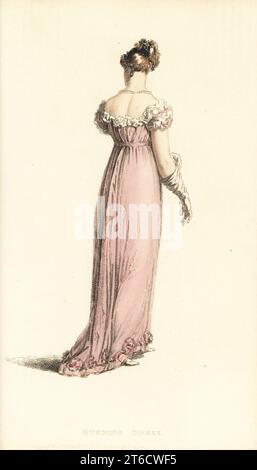 Regency woman in elegant evening dress. Robe of blossom-coloured crepe with demi train, white satin trim and belt, hair in irregular curls with autumn flowers, pearl necklace and earrings, French kid gloves, satin slippers. Plate 34, Vol. 10, November 1, 1813. Handcoloured copperplate engraving by Thomas Uwins from Rudolph Ackermann's Repository of Arts, London. Stock Photo