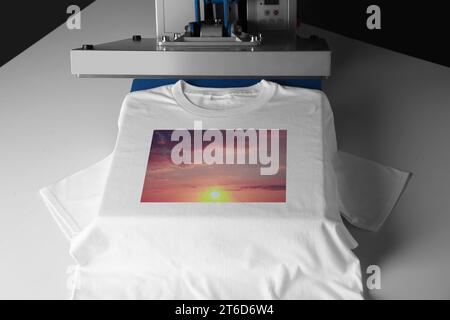 Custom t-shirt. Using heat press to print image of beautiful sunset sky Stock Photo