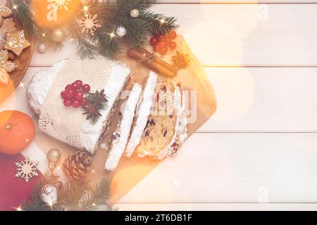 Beautiful composition with Christmas Stollen and space for text on white wooden table, flat lay. Bokeh effect Stock Photo