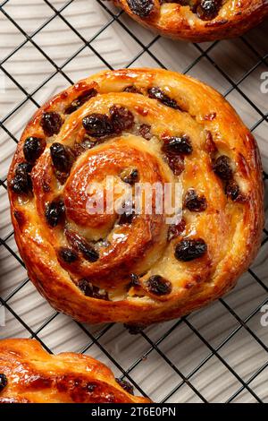 Pain aux raisins, also called escargot or pain russe, is a spiral pastry often eaten for breakfast in France. Its names translate as raisin bread, sna Stock Photo