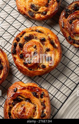 Pain aux raisins, also called escargot or pain russe, is a spiral pastry often eaten for breakfast in France. Its names translate as raisin bread, sna Stock Photo