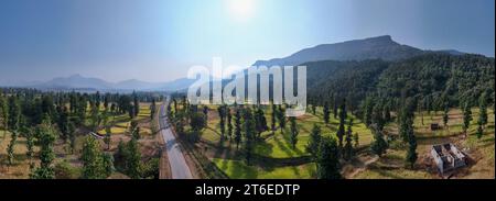 Beautiful Aerial panorama of mountain in forest with road passing through mountain. Stock Photo