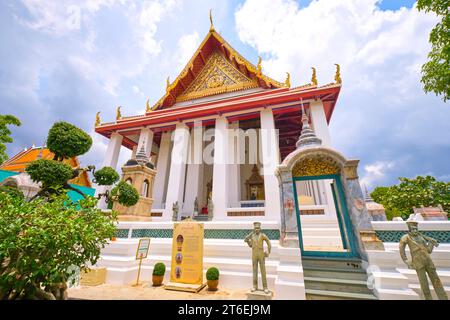 Exterior view of the looming temple with tall, white columns. At Phra Ubosot Wat Suthat in Bangkok, Thailand. Stock Photo