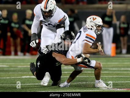 Louisville, United States. 09th Nov, 2023. Virginia Cavaliers quarterback Anthony Colandrea (10) is tackled by University of Louisville's Mason Reiner (95) during the first half of play at L&N Stadium on Thursday, November 8, 2023 in Louisville, Kentucky. Photo by John Sommers II/UPI Credit: UPI/Alamy Live News Stock Photo