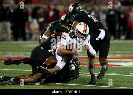 Louisville, United States. 09th Nov, 2023. Virginia Cavaliers quarterback Anthony Colandrea (10) is tackled by University of Louisville's Devin Neal (27) during the first half of play at L&N Stadium on Thursday, November 8, 2023 in Louisville, Kentucky. Photo by John Sommers II/UPI Credit: UPI/Alamy Live News Stock Photo