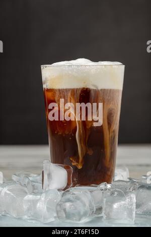 Iced coffee latte in glass cup on wooden table Stock Photo