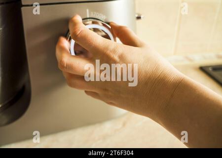 hand using.  Girl Adjusting Temperature Of Microwave Oven.Using microwave oven. power regulator, temperature control Stock Photo