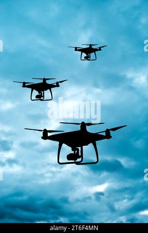 silhouette of drones in formation Stock Photo