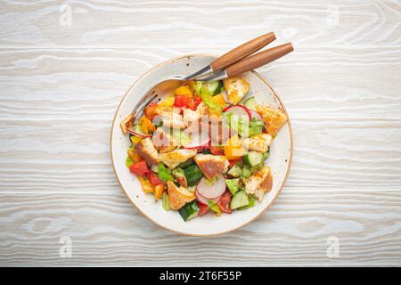 Traditional Levant dish Fattoush salad, Arab cuisine, with pita bread croutons, vegetables, herbs. Healthy Middle Eastern vegetarian salad, rustic Stock Photo