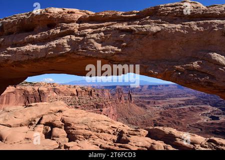 panoramic red rock  canyon view through scenic  mesa arch on a sunny day  in canyonlands national park, utah Stock Photo