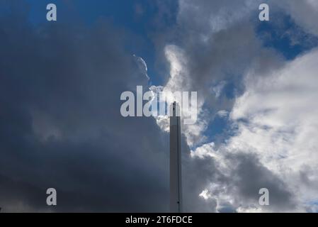 Cloudy sky with chimney of the thermal power station, Erlangen, Middle Franconia, Bavaria, Germany Stock Photo