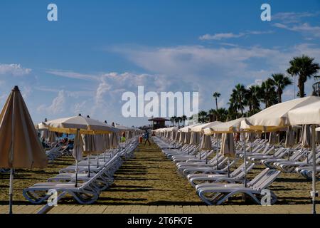 Empty sun loungers on beach in Larnaca, Cyprus Stock Photo