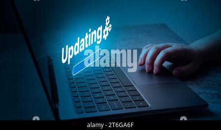 Woman updating software on laptop. System engineer and programming. Software apps developer. Stock Photo