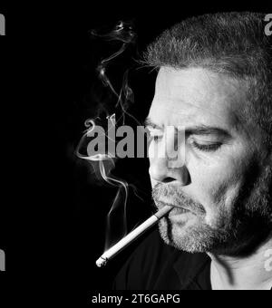middle aged man smoking a cigarette Stock Photo