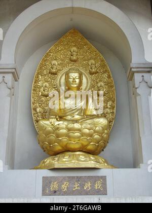 Gold Buddha statue, Buddhist Peace Pagoda in Battersea Park London, Stock Photo