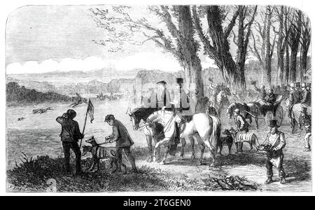 Coursing meeting at Hampton Park, 1860. Engraving  from a sketch by Mr. Elstob Marshall. '...the Hampton Meeting is the great rendezvous for Cockney coursers...This year the coursing at the Champion Meeting was...extremely good on the second [day]; but the hares are unusually scarce, and it will be difficult to find enough of them to last through the season. The grass, too, is unusually long, which, coupled with the wet season, has caused them to run rather weak...[The scene depicts] deciding the course for the Victoria Stakes between Mr. Purser's Pride of the Village, by Black Cloud, and Mr. Stock Photo