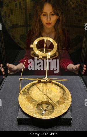 London, UK.  10 November 2023. A staff member views a 17th-century Safavid brass Mecca Centred World Map, (Est. £1,500,000-2,000,000) at a preview of Bonhams Islamic and Indian Art sales.  Lots will be auctioned at Bonhams New Bond Street galleries on 14 November.  Credit: Stephen Chung / Alamy Live News Stock Photo