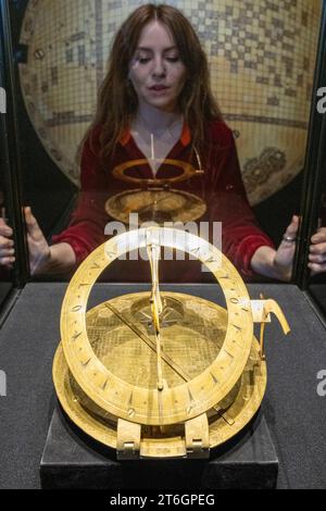 London, UK.  10 November 2023. A staff member views a 17th-century Safavid brass Mecca Centred World Map, (Est. £1,500,000-2,000,000) at a preview of Bonhams Islamic and Indian Art sales.  Lots will be auctioned at Bonhams New Bond Street galleries on 14 November.  Credit: Stephen Chung / Alamy Live News Stock Photo