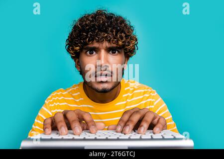 Photo of speechless impressed person staring fingers typing write keyboard isolated on teal color background Stock Photo